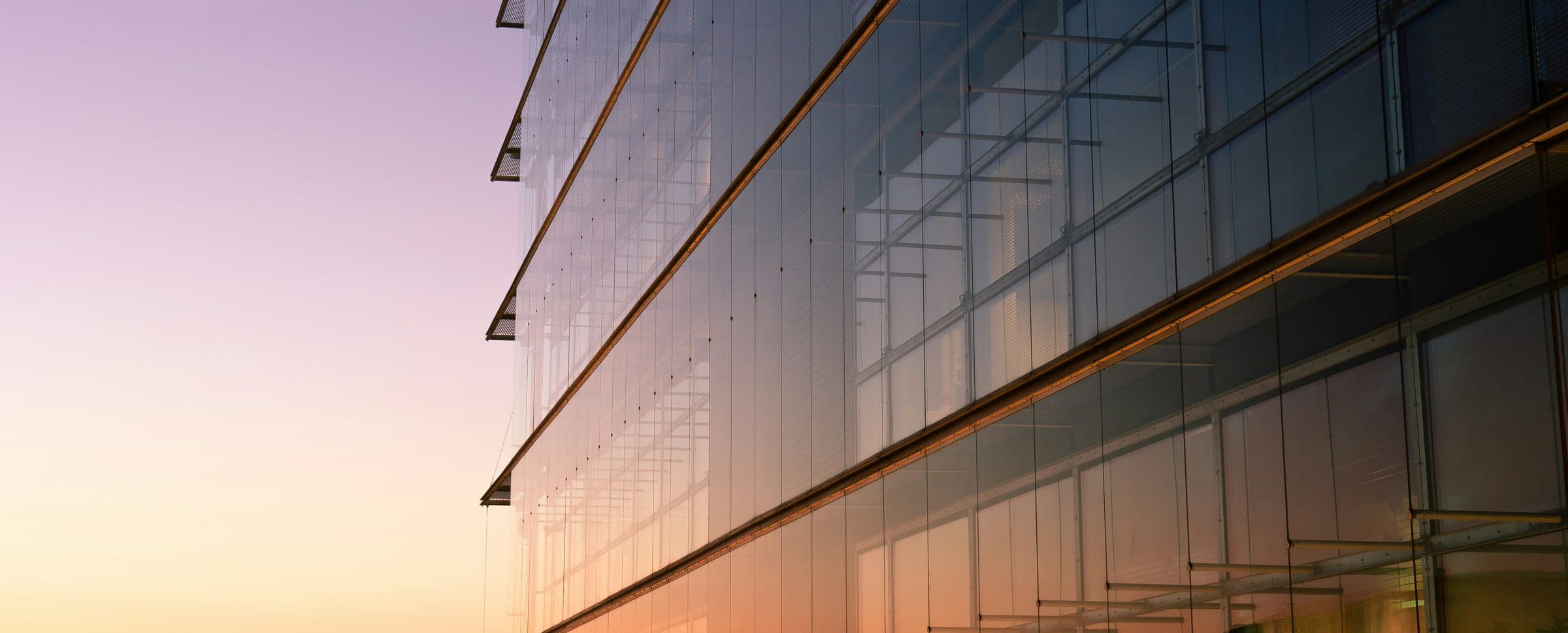 Glass office building at dusk